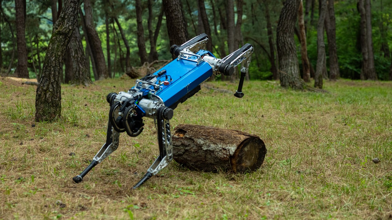 Quadruped robot jumping over a log in a forest