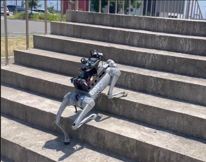 Unitree Go1 quadruped robot climbing outdoor concrete stairs